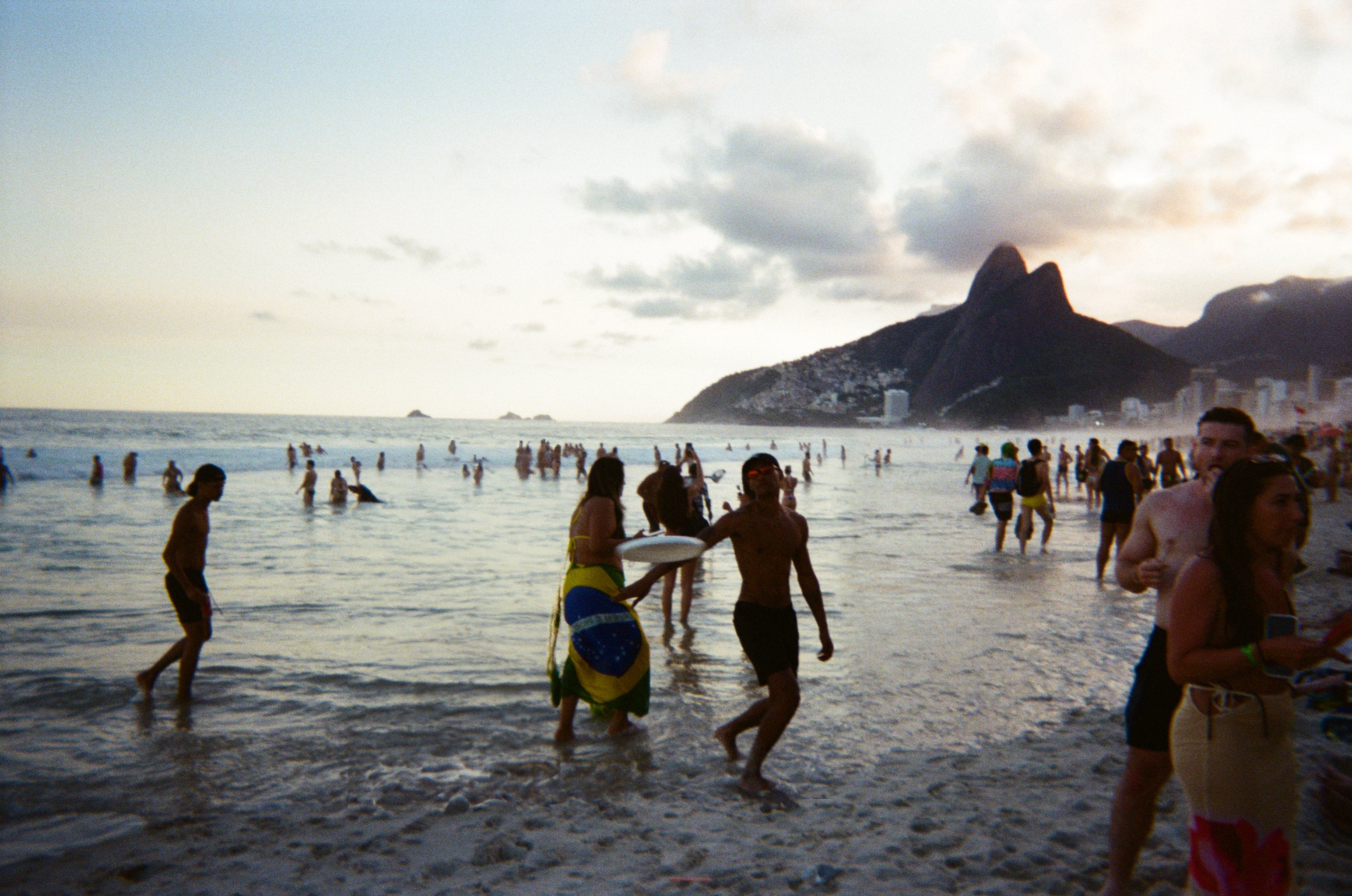 a man playing ultimate frisbee on the beach
